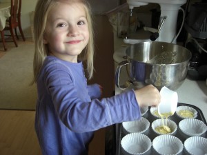 Isabelle helping make birthday cupcakes